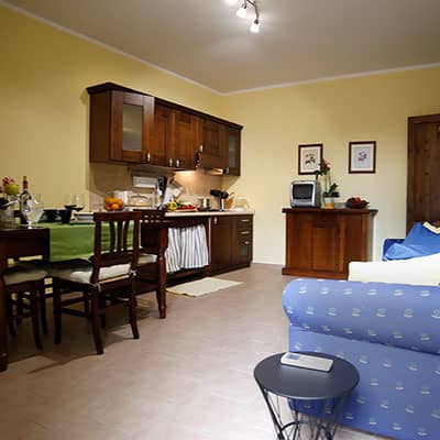 Clio. Welcoming living area with kitchenette and sofa bed. Le Muse Vacation Apartments Bevagna historic center
