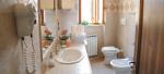 Bathroom with walk-in shower and washing machine - Tersicore Vacation Apartment in Bevagna, Umbria, Italy