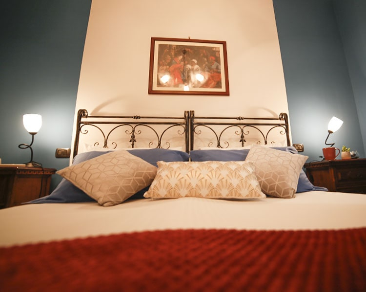 The headboard of the bed is in wrought iron -  Le Muse vacation apartment Bevagna, Umbria, Italy