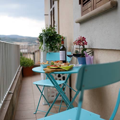 Clio. A balcony surrounding the apartment. Le Muse Holiday Apartments Bevagna historic center
