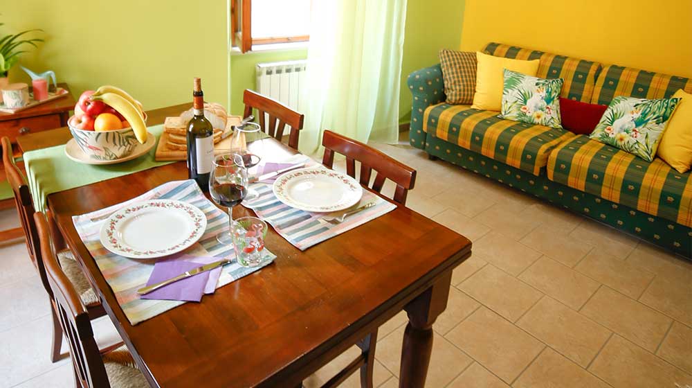 Talia. Living area with large sofa bed. Le Muse Holiday Apartments Bevagna historic center
